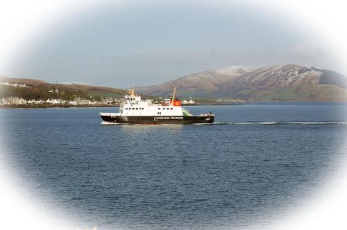 a large boat in a large body of water at Highlander House Boutique Hotel in Rothesay