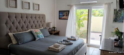 a bedroom with a large bed with a large window at Las Palmas - New Horizon in Dixon Cove