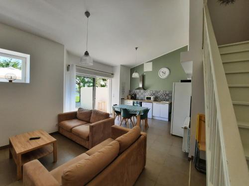 a living room with a couch and a table at Gite 4 personnes avec piscine entre Saintes et Royan in Balanzac