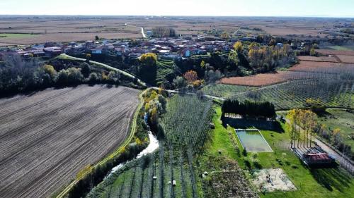 an aerial view of a field and a town at Miradoralaribera Chalet rural in Alcoba de la Ribera