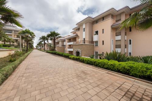 a brick road in front of some apartment buildings at Appartement 300m2 vue sur océan Prestigia - Plage des nations in Sale