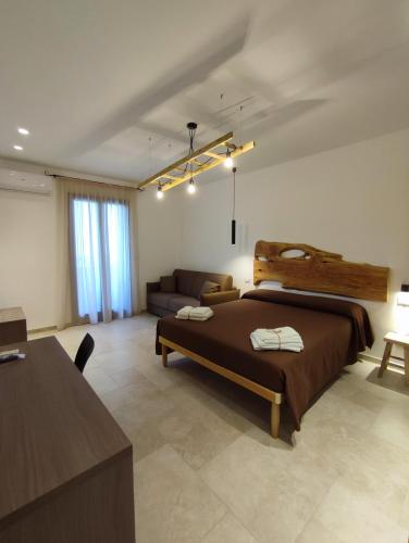 a bedroom with a large bed and a couch at B&B San Vito in Tricase