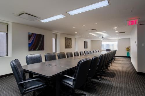 a conference room with a long table and chairs at Arc The Hotel in Ottawa