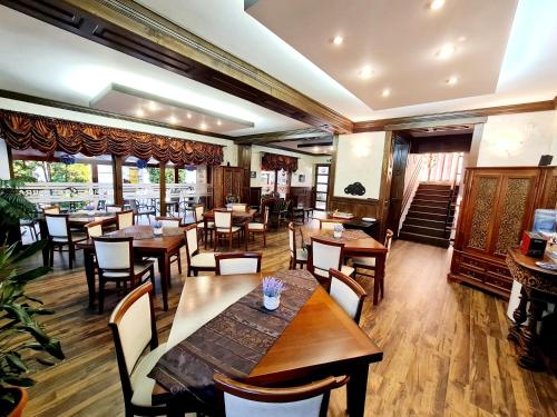 a dining room with wooden tables and chairs at Pension Terra in Alba Iulia