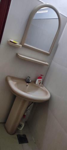 a bathroom with a sink and a mirror at Sunset Villa in Negombo