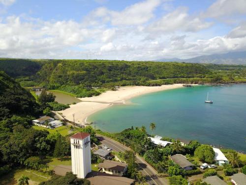 an aerial view of a beach with a boat in the water at Waimea Bay Luxury Estate Views & Hot Tub in Haleiwa