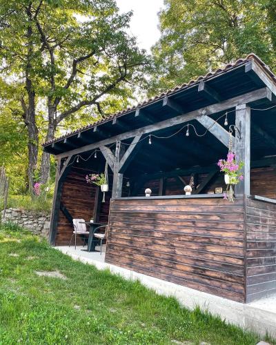 a wooden pavilion with a table and flowers in it at Transylvania Mountain View CDI in Bran