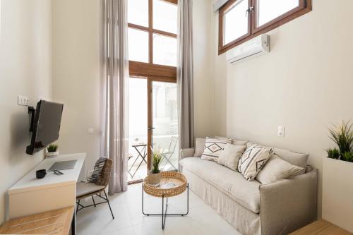 a living room with a couch and a table at Palm Residences in Pefkohori