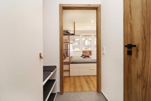 a hallway with a door leading into a kitchen at Appartements Eisenstein in Bayerisch Eisenstein