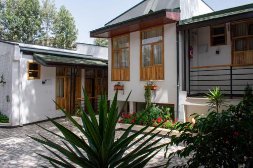 a house with a plant in front of it at Choice Guest House 2 in Addis Ababa