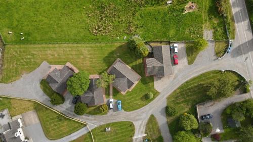 an overhead view of a house with cars on a road at Glenview Chalet Park in Inverness