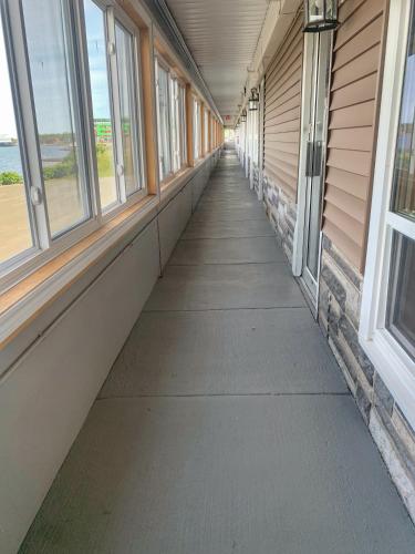 an empty hallway of a building with windows at Harbourview Inn and Suites in Sydney
