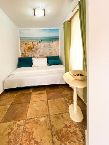 a bedroom with a bed and a view of the beach at La Konac in Murighiol