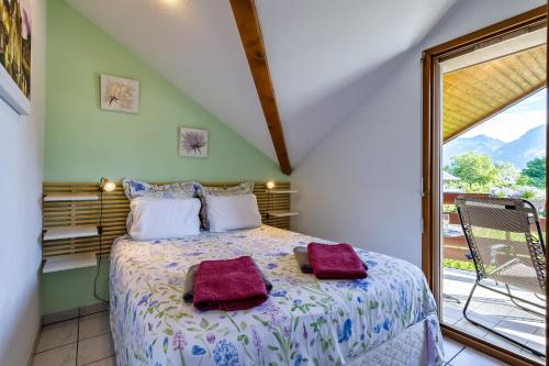 a bedroom with a bed with two towels on it at Apartplage in Saint-Jorioz