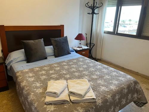 a bedroom with a bed with two towels on it at APARTAMENTO 1 LINEA MORAIRA in Moraira