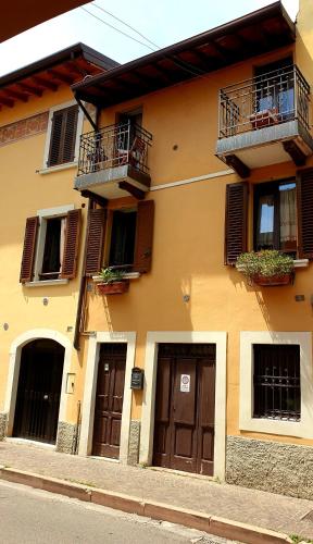 a building with brown doors and windows and balconies at Acquadolce in Salò