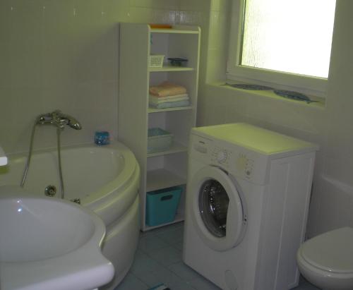 a bathroom with a washing machine and a sink at Kotor in Crikvenica
