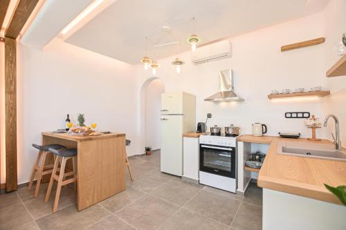 a kitchen with a sink and a refrigerator at Naxos Pantheon Luxury Apartments in Agkidia