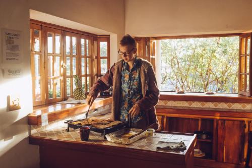 a man standing in a kitchen preparing food at Spanish by the River - Boquete in Boquete