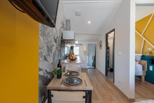 a kitchen with a wooden counter and a yellow wall at Cosy Apparts Saintes in Saintes
