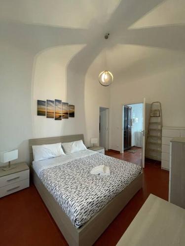 a bedroom with a large bed and a ladder at La casa del mare in Savona