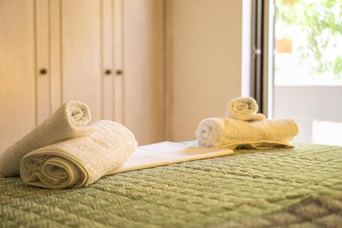 a pair of towels on a bed at Blossom Apartment Kos in Ampavris