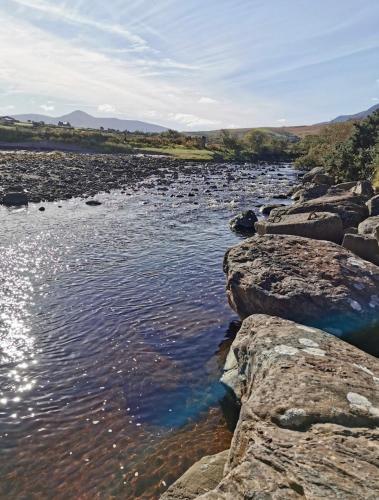 a river with some rocks in the water at The Cé Hideout in Tralee