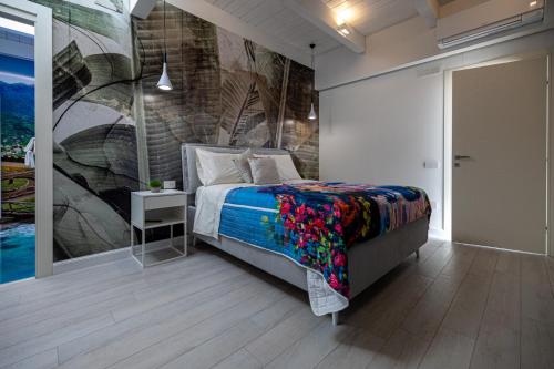 a bedroom with a bed and a painting on the wall at Room Ravello in SantʼAntonio Abate