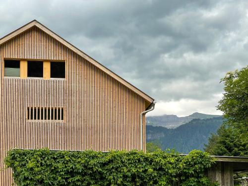 a house with a large window on the side of it at Wasserfall Apartments Mellau in Mellau