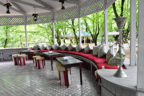 a group of tables and chairs in a pavilion at Vilesh Palace Hotel in Masallı