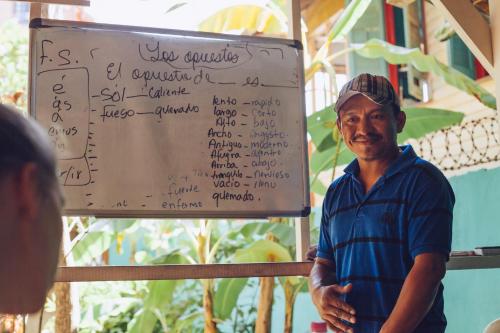 a man standing in front of a sign at Spanish by the Sea - Bocas in Bocas Town