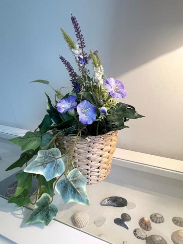 a basket filled with flowers sitting on a table at The Cé Hideout in Tralee