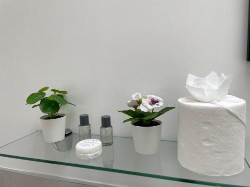 a glass table with flowers and cosmetics on it at The Cé Hideout in Tralee