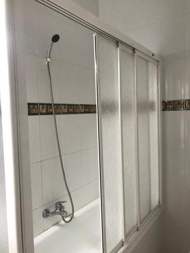 a shower in a bathroom with a tub at Hospedería Nuestra Sra de las Caldas in Las Caldas de Besaya