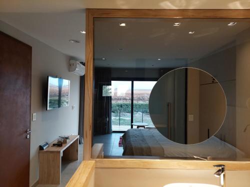 a bathroom with a mirror and a bed in a room at Casa de Huéspedes La Azul in Los Árboles