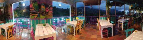 a restaurant with tables and chairs in a room at El Patio de mi Casa Hotel Restaurante in Salento