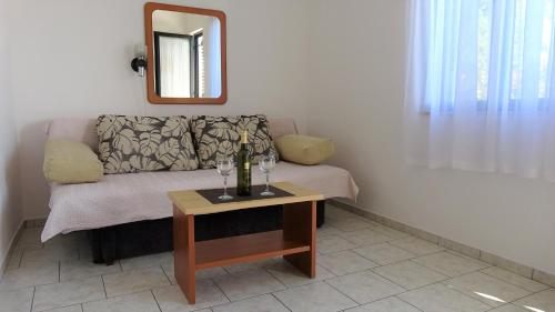 a living room with a couch and a table at 35 meters from sea Apartment Keser and House for rent in Karlobag