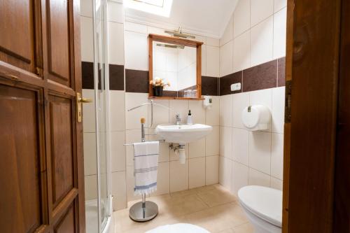 a bathroom with a sink and a toilet at Szeparé pinceház szállás Villány központi részén. in Villány