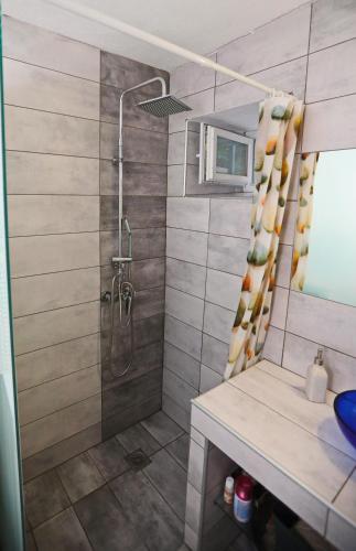 a bathroom with a shower and a sink at iLposto Down in Kavala