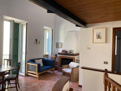 een woonkamer met een blauwe stoel en een tafel bij La luce del borgo in Castel Gandolfo