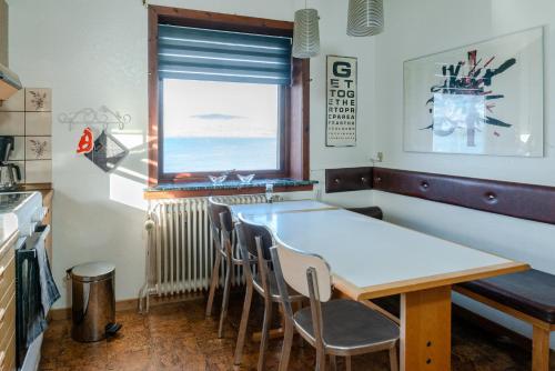 a dining room with a table and chairs and a window at 3 Bedroom Apartment / Great Sea View / Quiet in Tórshavn