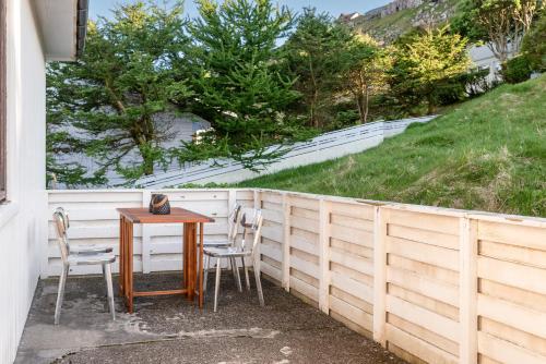 a table and chairs next to a fence at 3 Bedroom Apartment / Great Sea View / Quiet in Tórshavn