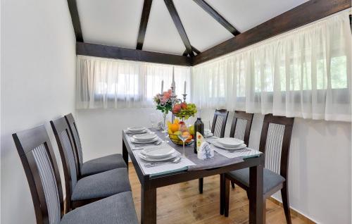 a dining room with a table and chairs at 5 Bedroom Cozy Home In Desni Stefanki in Desni Štefanki