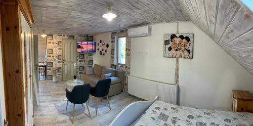 a bedroom with a bed and a living room at T.H.NY Village Inn Cottage in Tihany