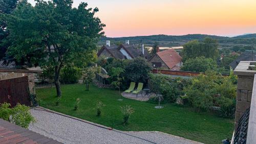 an aerial view of a yard with green chairs at T.H.NY Village Inn Cottage in Tihany