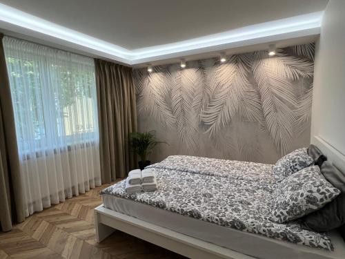Ένα ή περισσότερα κρεβάτια σε δωμάτιο στο Apartament Stylowy 2