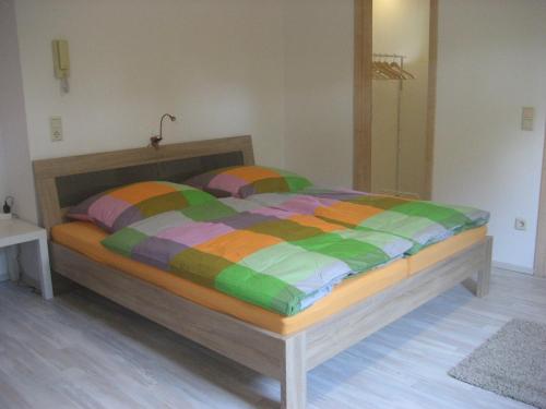 a bed with a colorful comforter in a bedroom at Apartment Herdrich in Rust