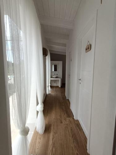 a hallway with a white curtain and a window at Tenuta viale degli ulivi in San Martino in Pensilis