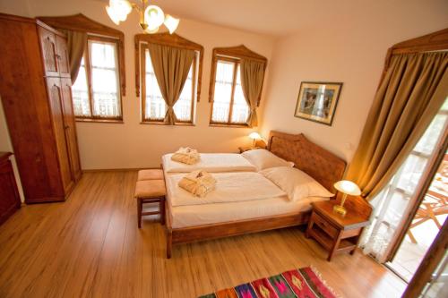 a bedroom with a bed in a room with windows at Boutique Hotel Old Town Mostar in Mostar