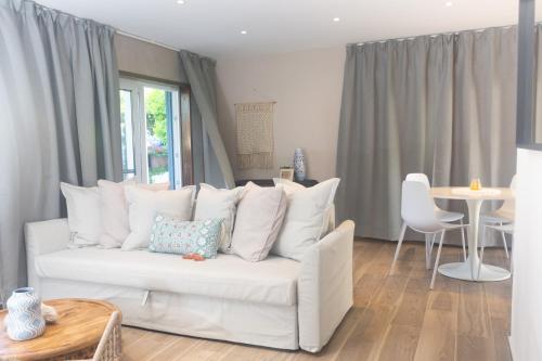 a living room with a white couch and a table at Tradewinds Apartments Simpson Bay in Simpson Bay